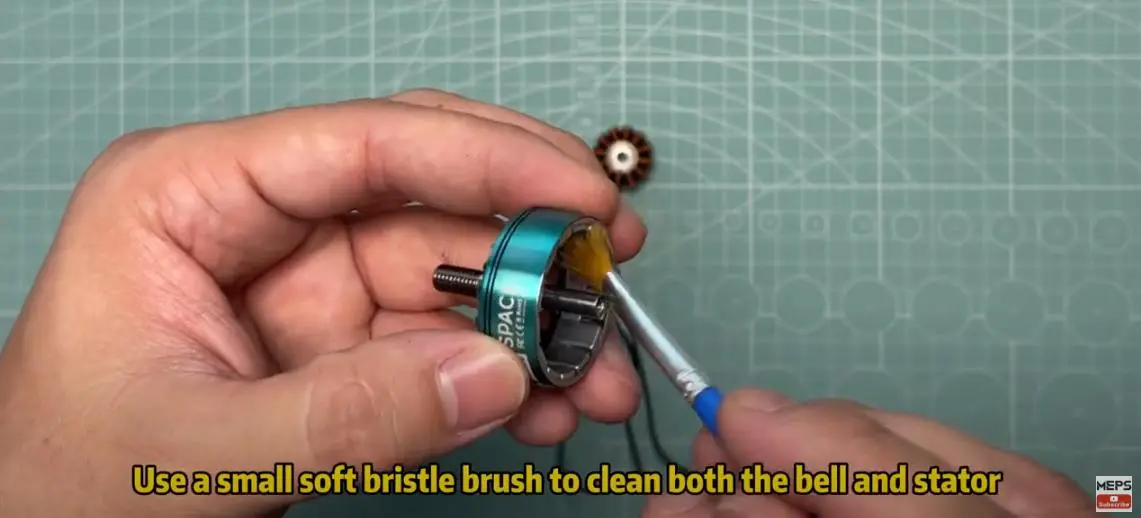 using brush to clean motor's bell 